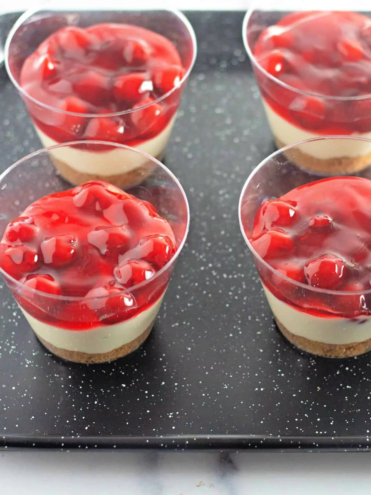 add cherry pie filling to the top of pudding cups.