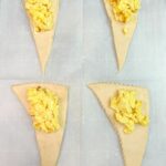 crescent roll triangles with scrambled eggs.