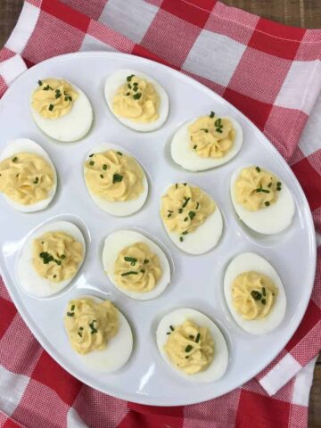 classic eviled eggs on white platter.