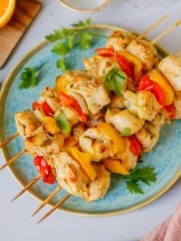 Grilled Chicken Kabobs served on a blue plate.