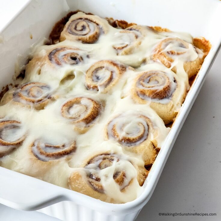 cinnamon rolls made with crescent rolls in a white baking dish.