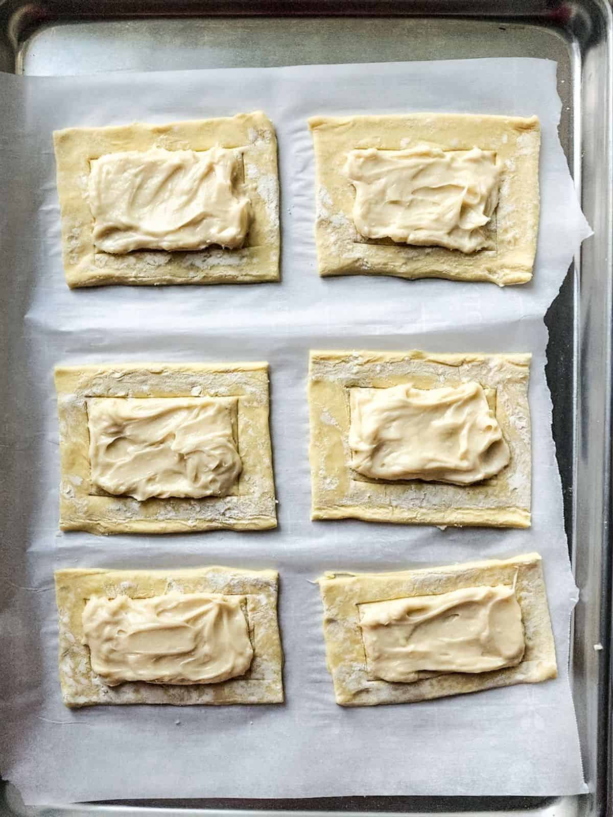 sweetened cream cheese mixture on top of puff pastry.