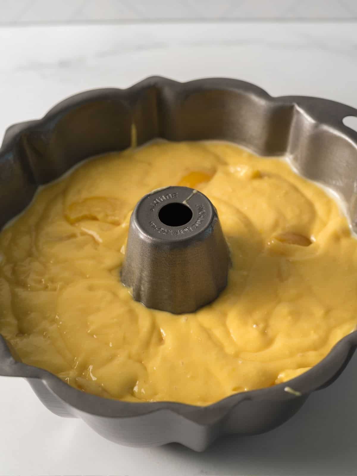 Peach cake batter in bundt pan.
