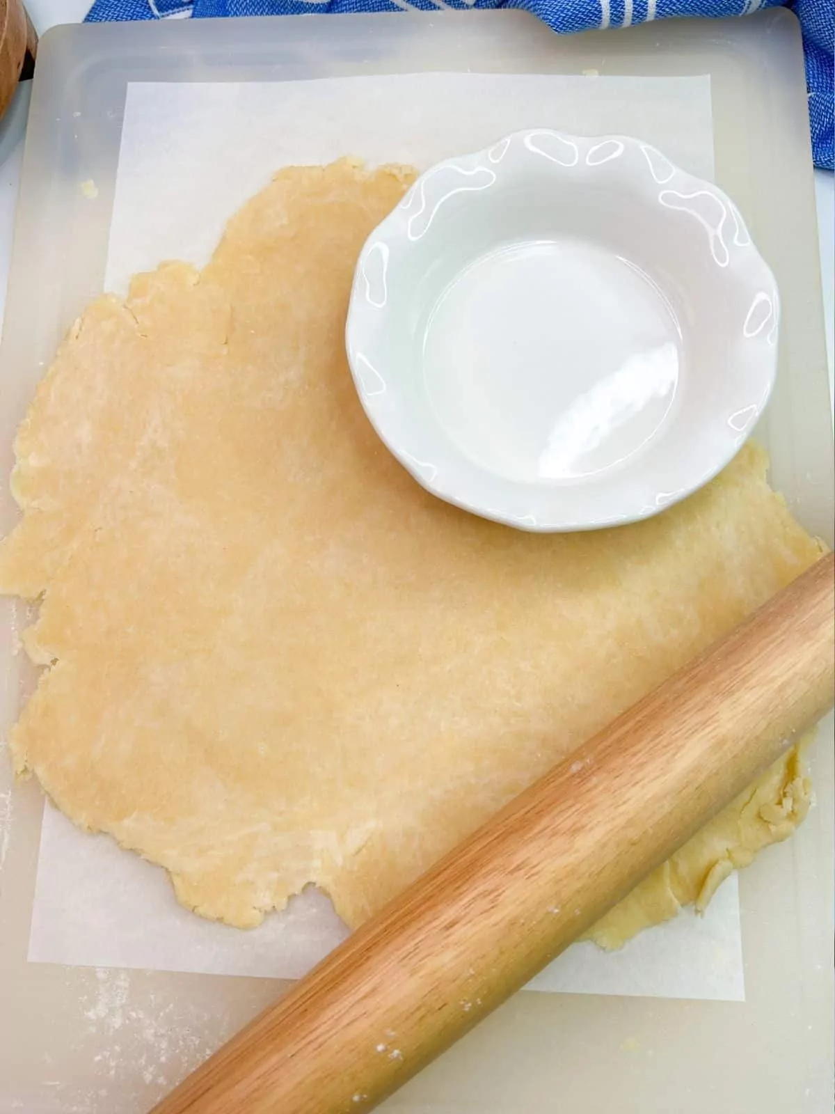 roll out pie crust dough with rolling pin.