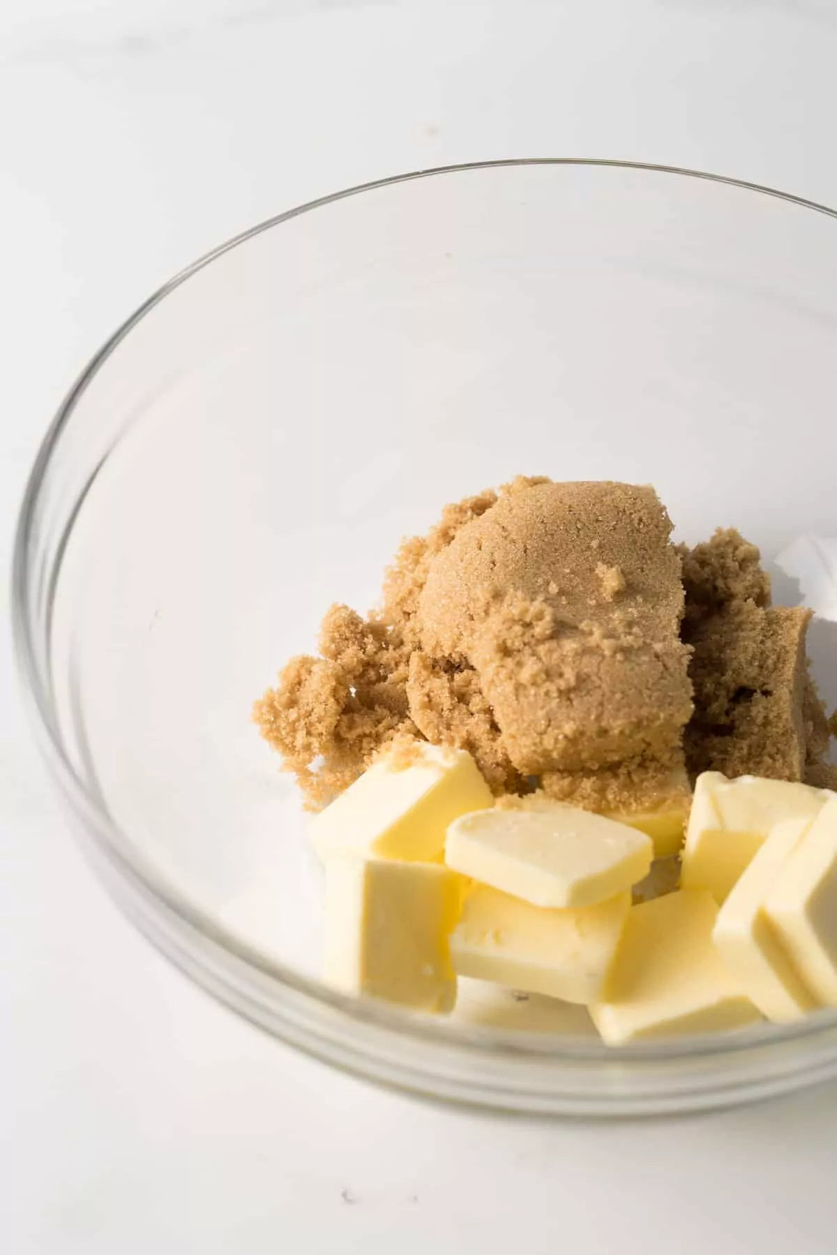 Swerve brown sugar with butter in glass mixing bowl.