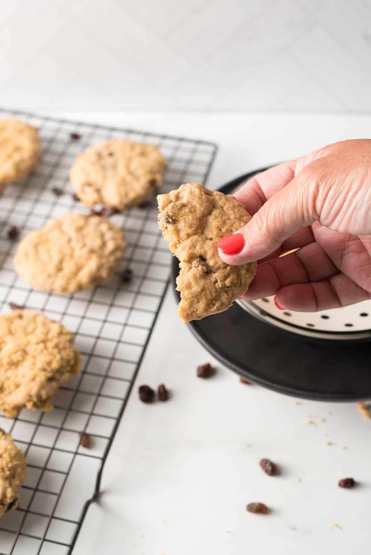 Holding sugar free cookie with first bite taken.