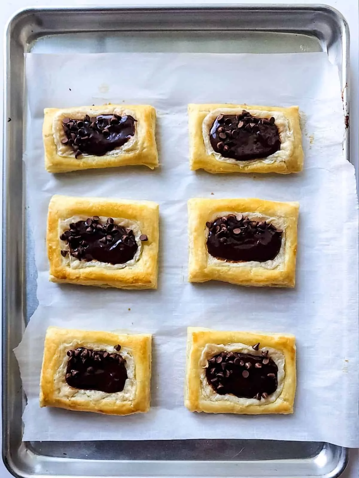 baked chocolate cream cheese puff pastry on tray.