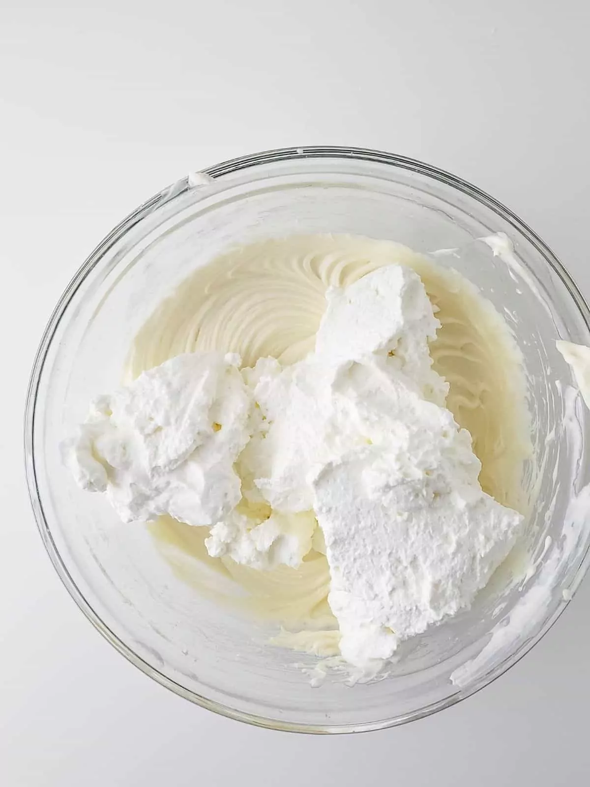 adding whipped cream to cream cheese mixture.