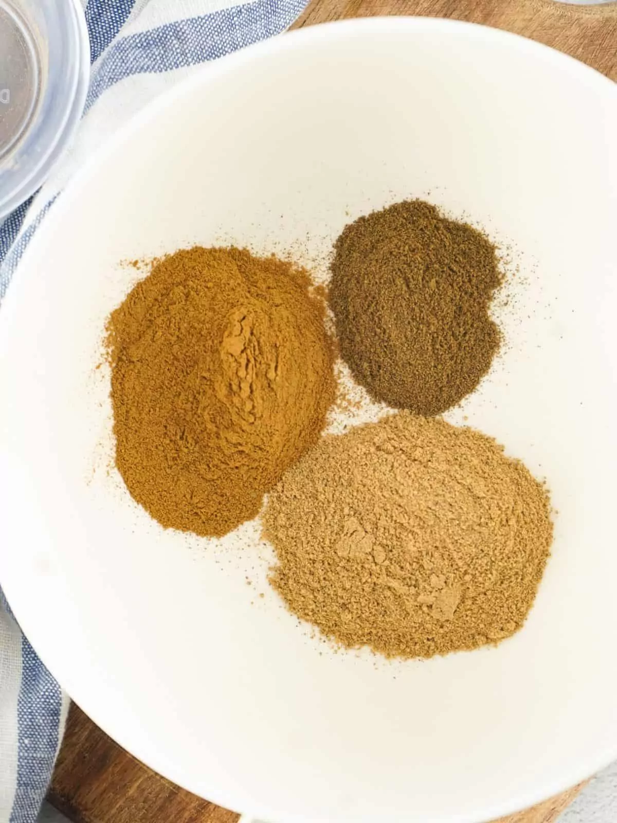 ingredients for allspice on white plate.