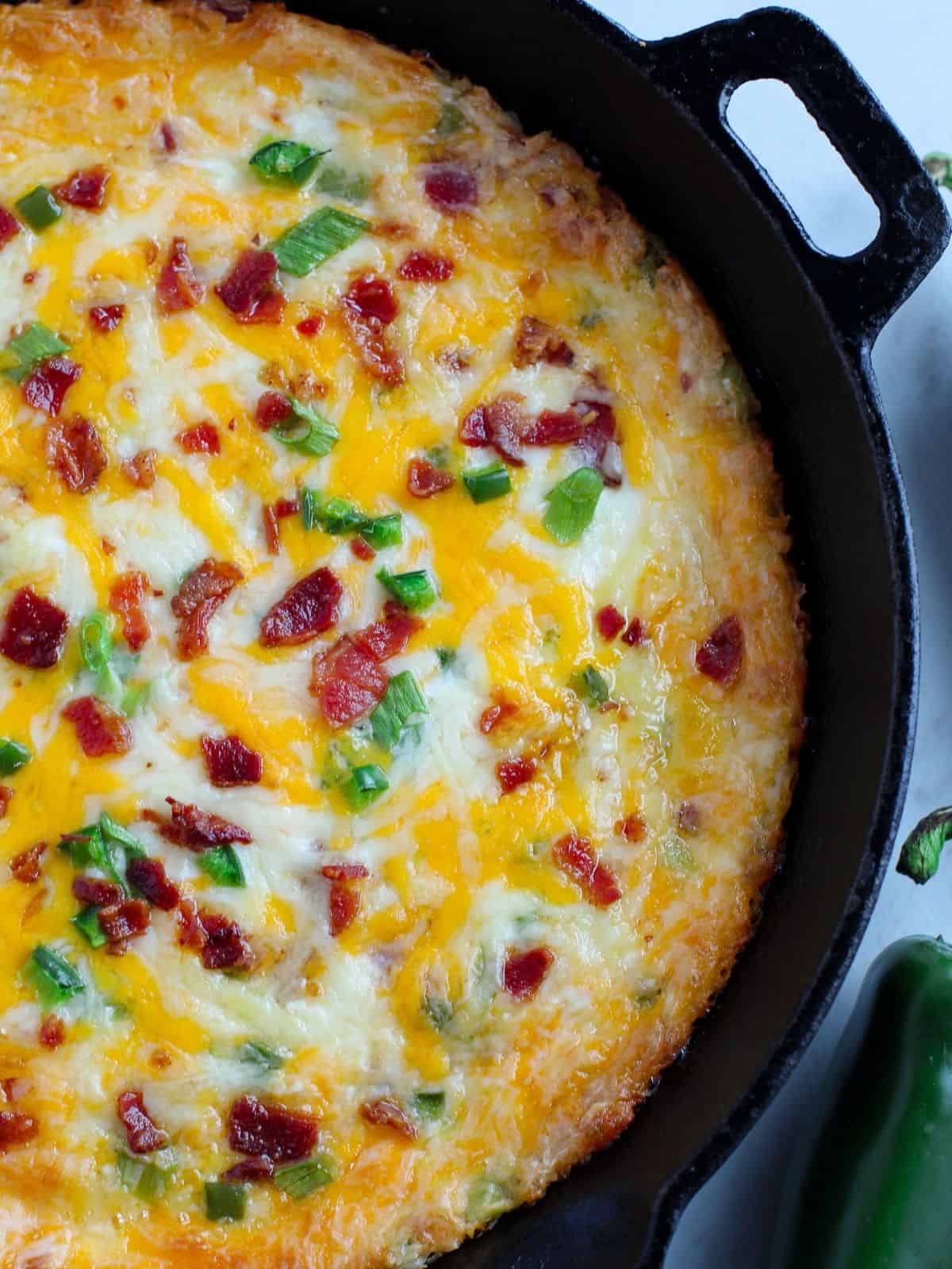 closeup of cheese jalapeno dip in cast iron skillet.