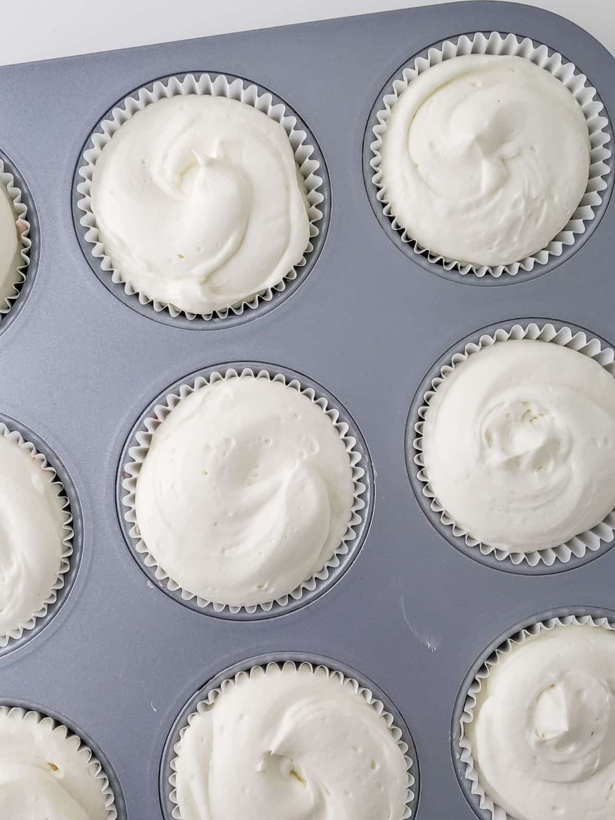 Cheesecake cupcakes in muffin pan.