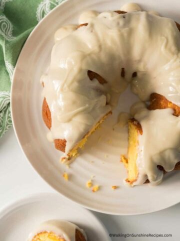 Peach Bundt Cake with slice on plate.