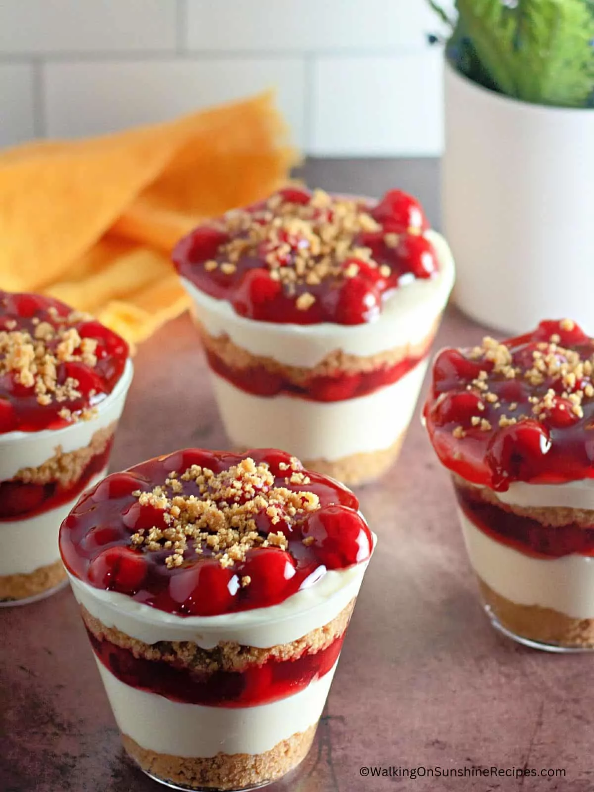 Cherry Cheesecake in a Jar with graham cracker layers.