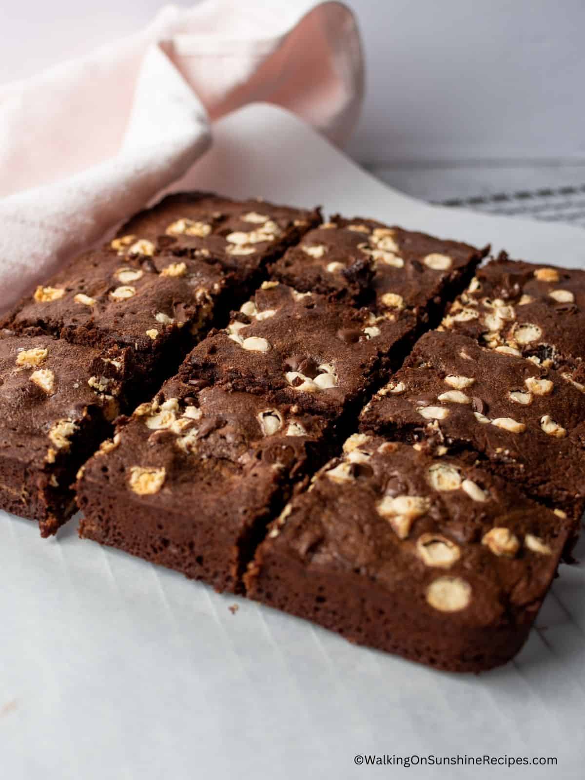 Sliced brownies on parchment paper.