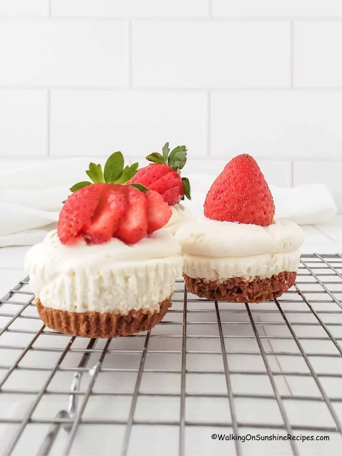 strawberry mini cheesecakes on baking rack.