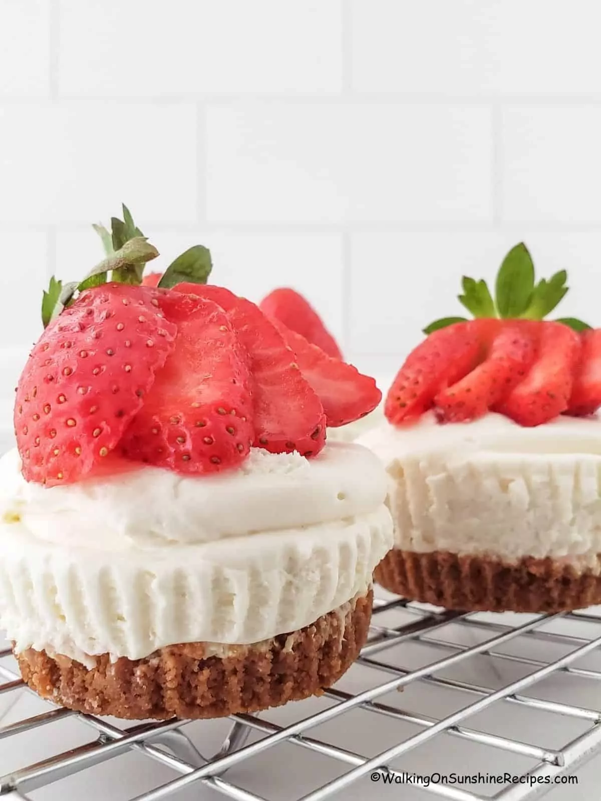 closeup of cheesecake cupcakes with strawberries.