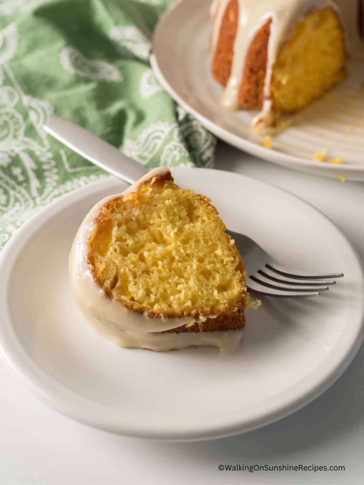 Sliced peach bundt cake with homemade cream cheese frosting.