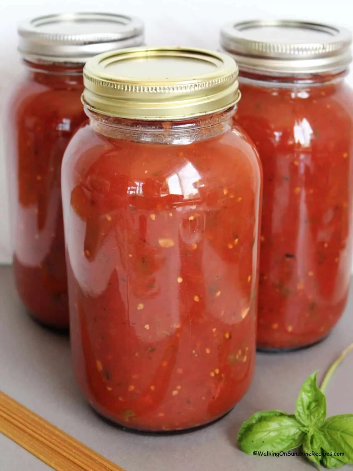 3 mason jars filled with homemade tomato sauce.