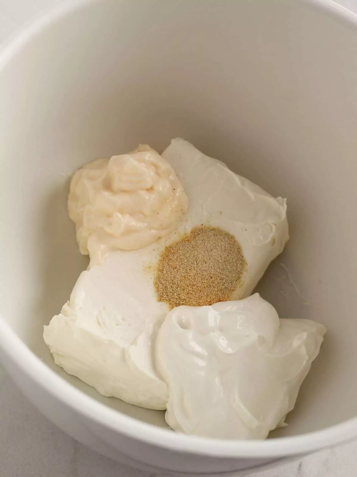 combine seasoning mixes with cream cheese and mayonnaise in white bowl.