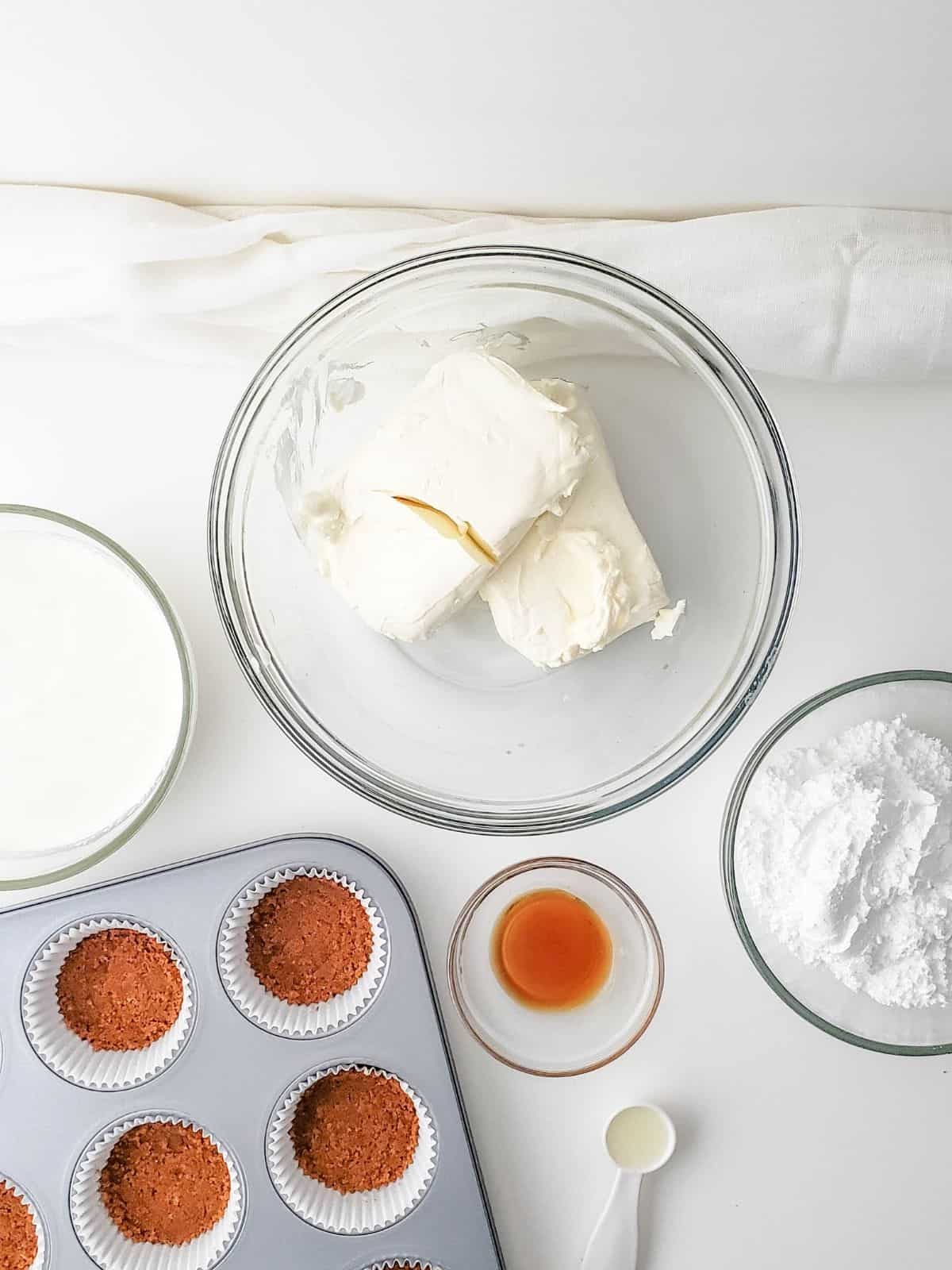 Press graham cracker crumbs into muffin pan.