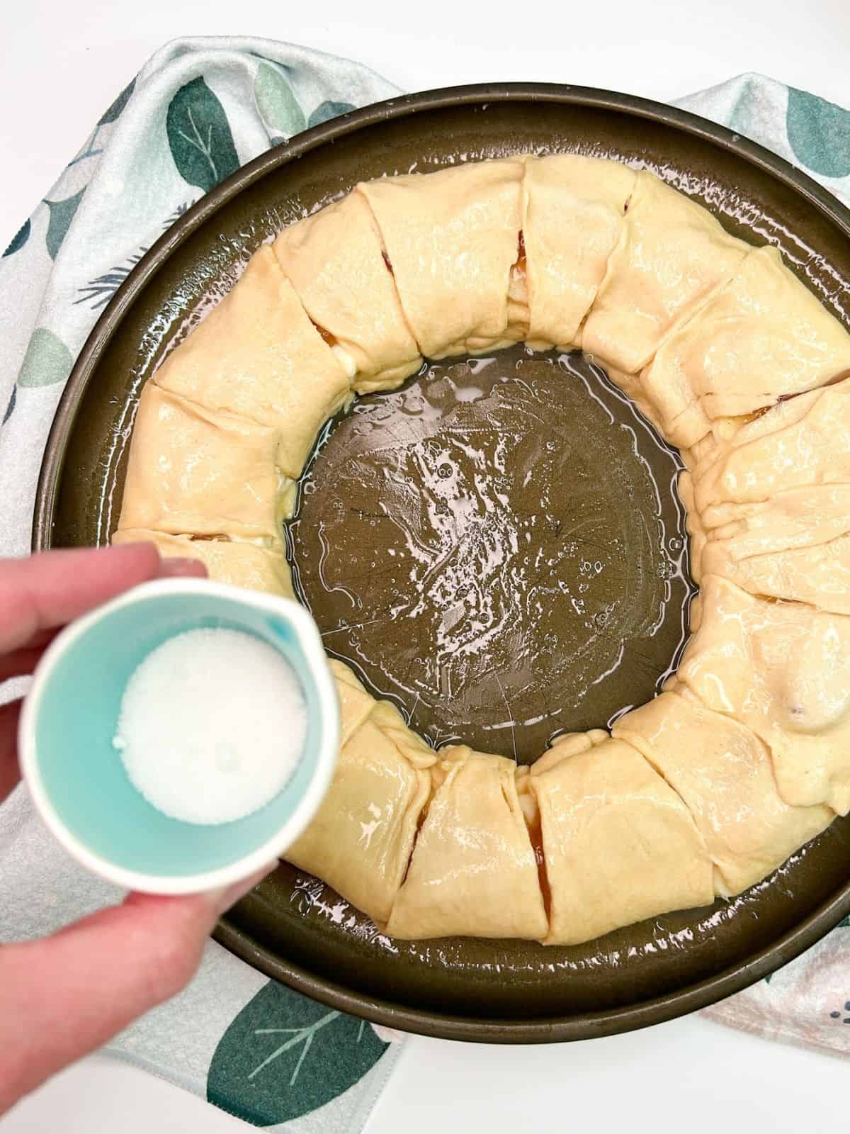 sprinkle sugar on top of crescent roll bake.