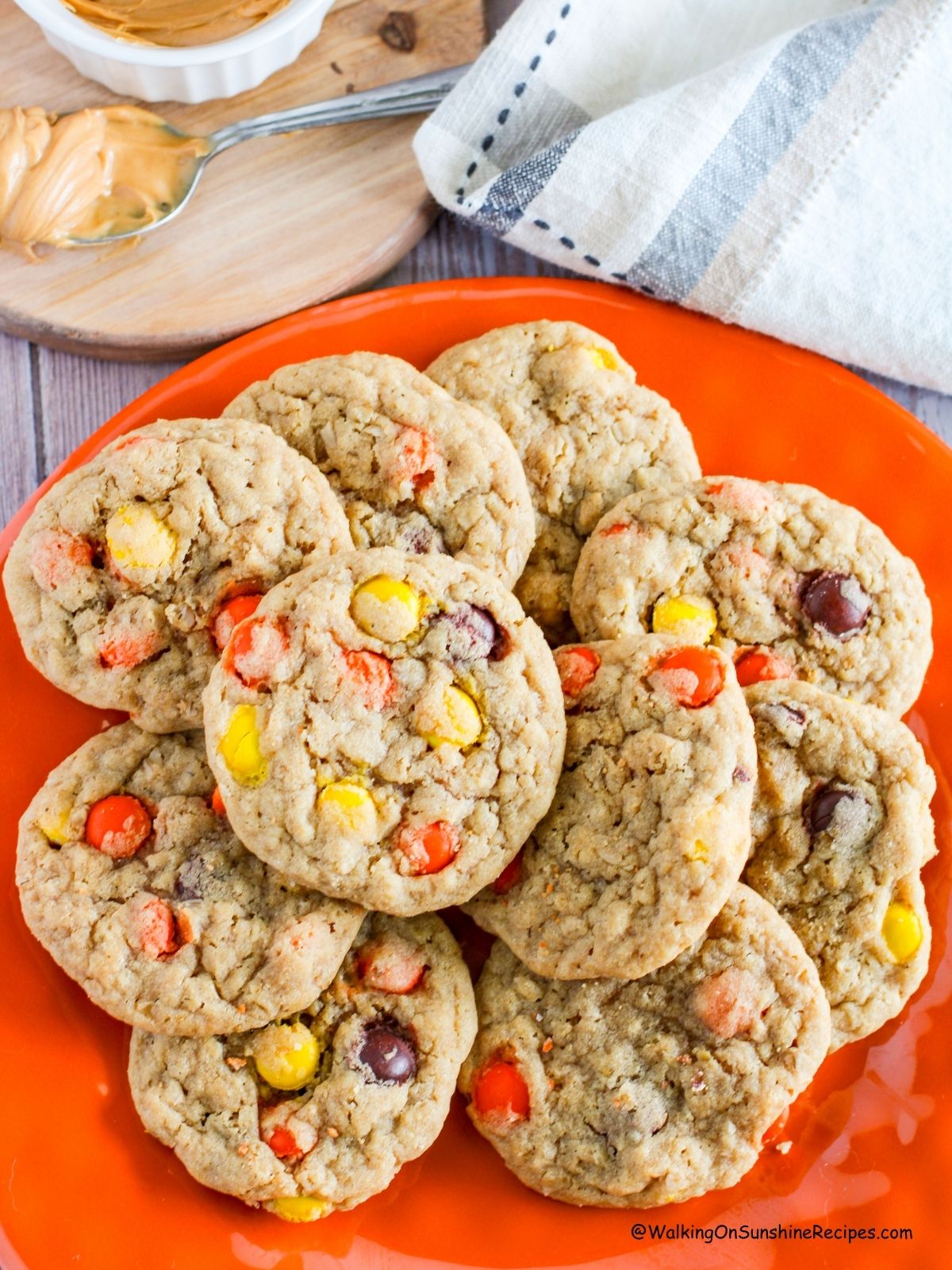 Peanut Butter Halloween Cookies with Reese's candy pieces on orange plate.