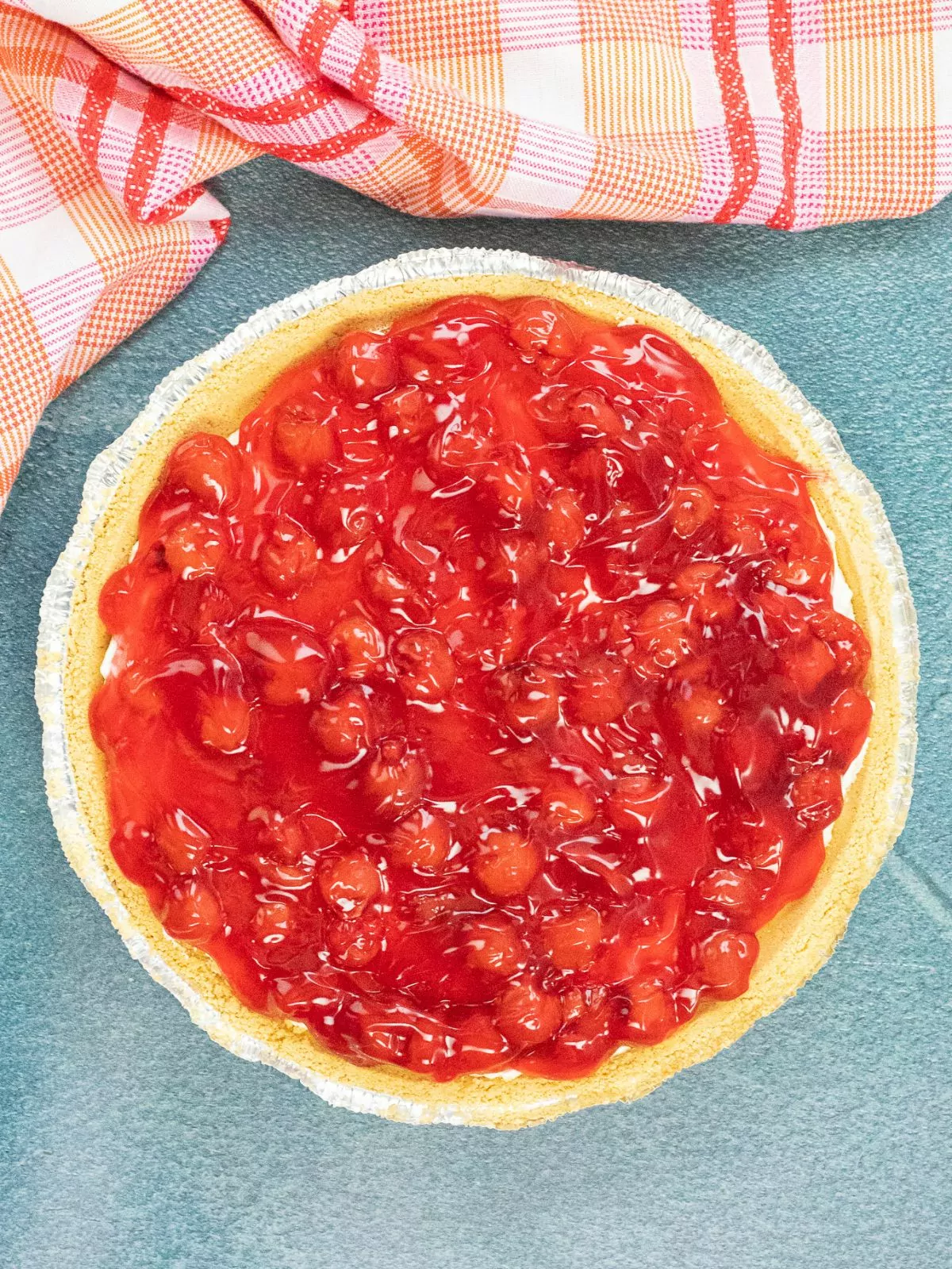 Cherry pie filling on top of no bake cheesecake pie.