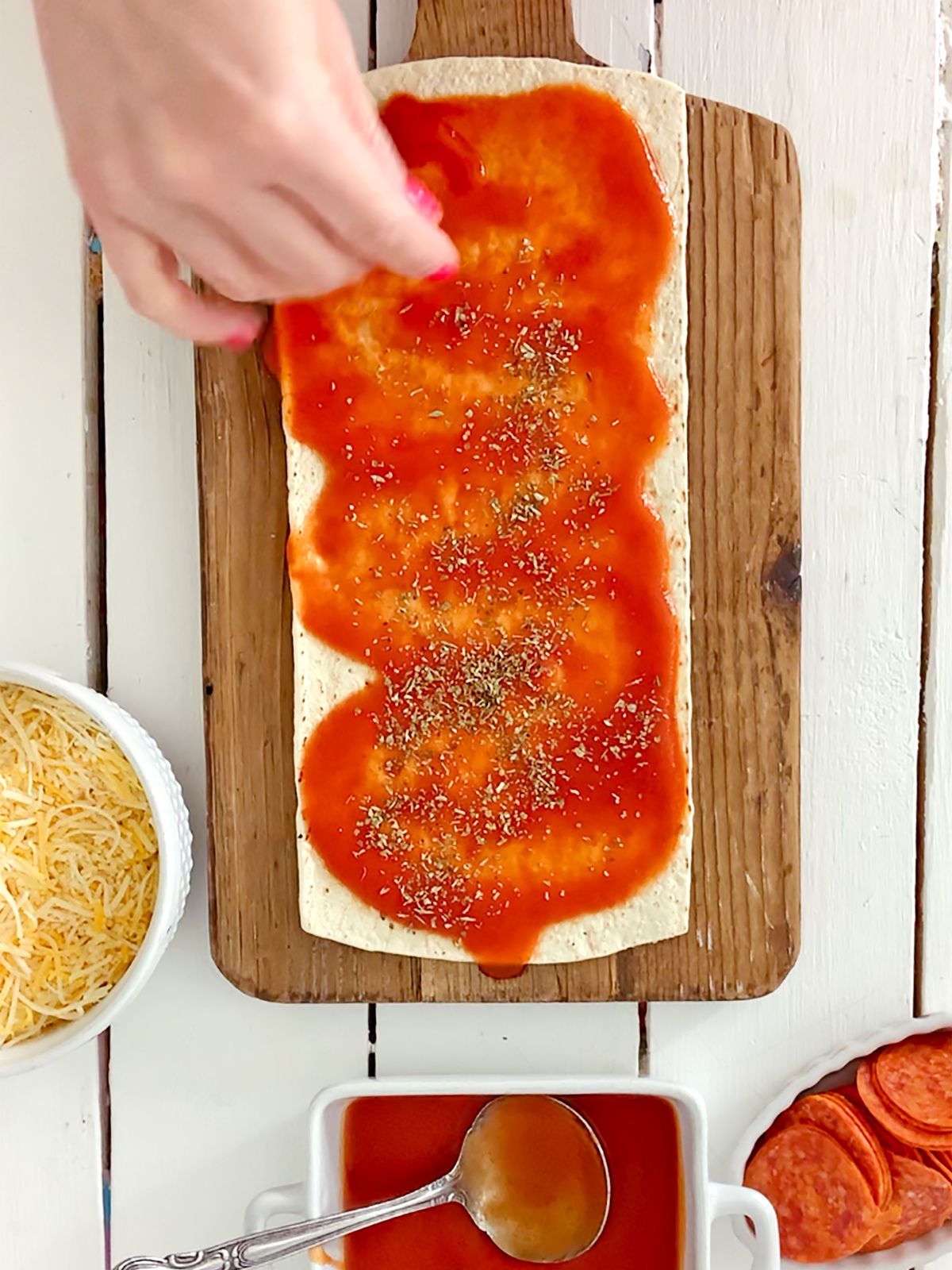 marinara sauce on flatbread with seasonings.