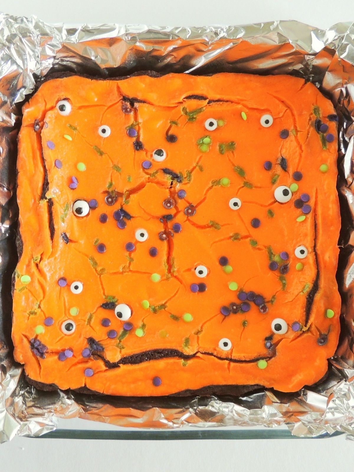 baked brownies with orange frosting.
