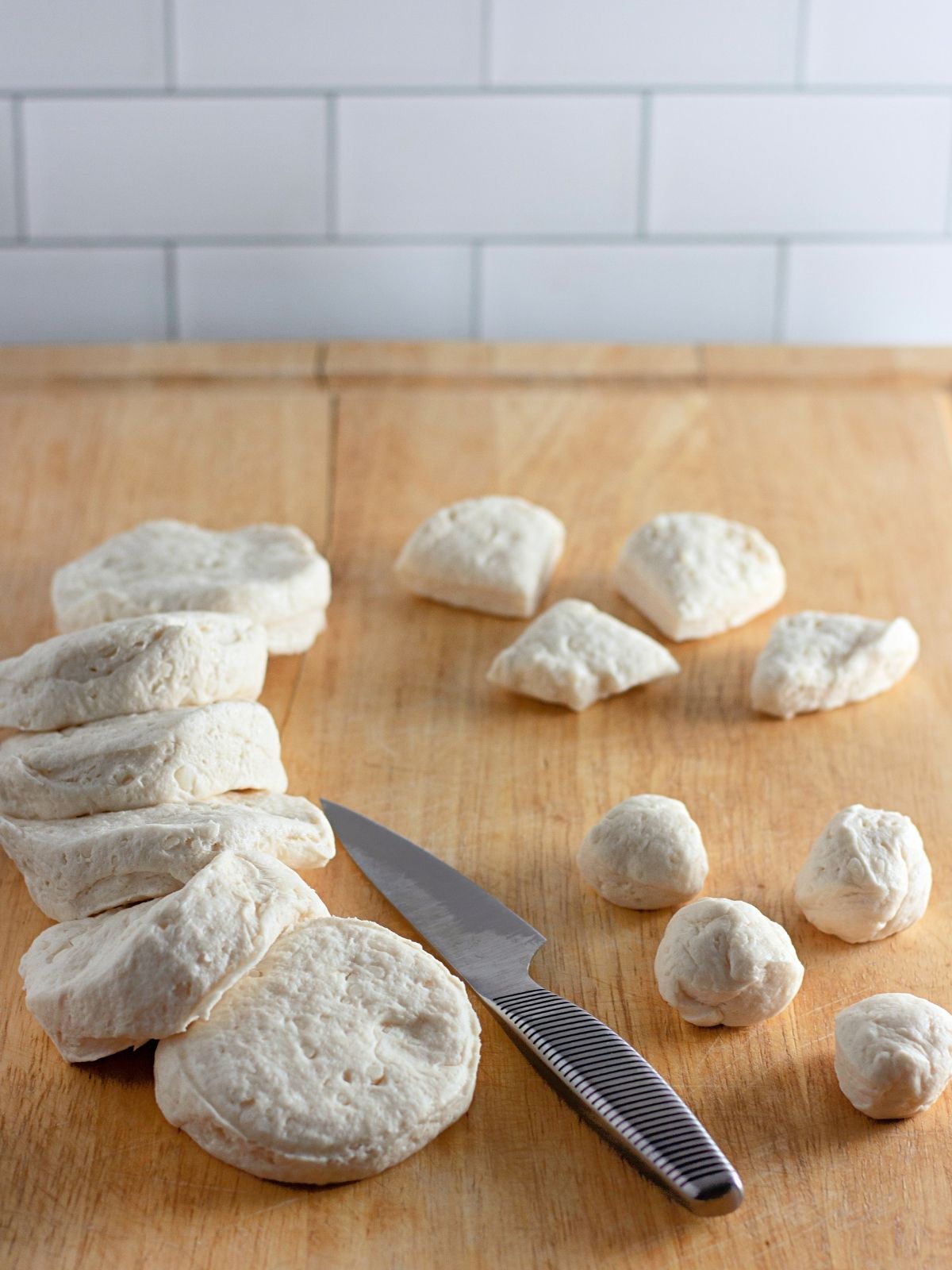 refrigerator dough biscuits sliced on cutting board.
