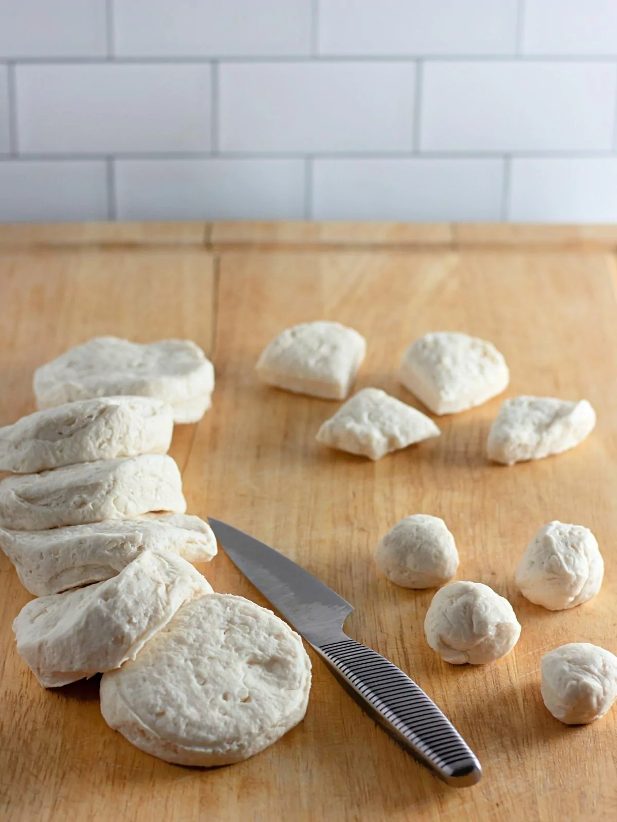 refrigerator dough biscuits sliced on cutting board.