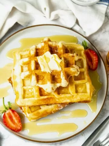 Homemade waffles served on plate.