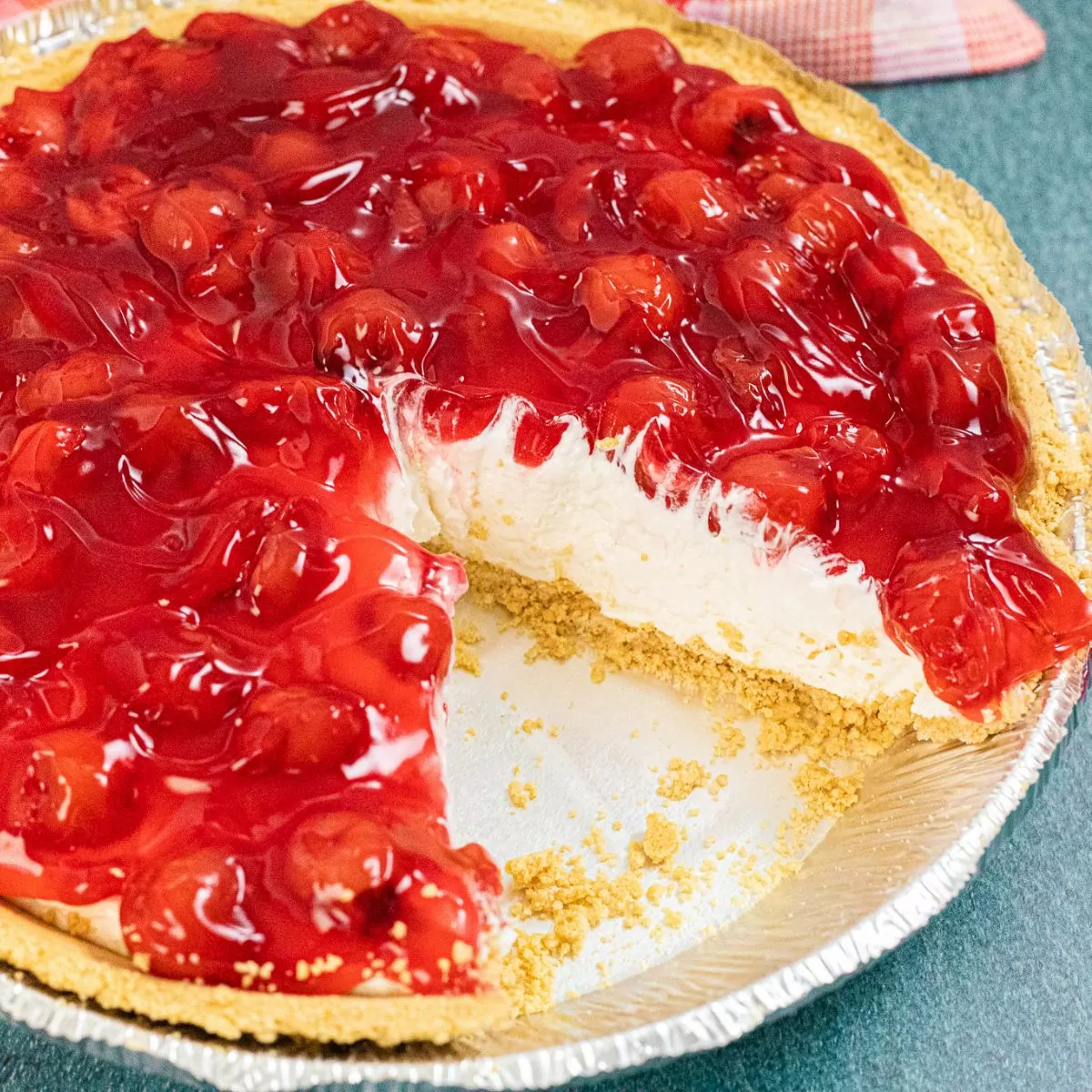 No Bake Cherry Cheesecake Pie with a slice taken out
