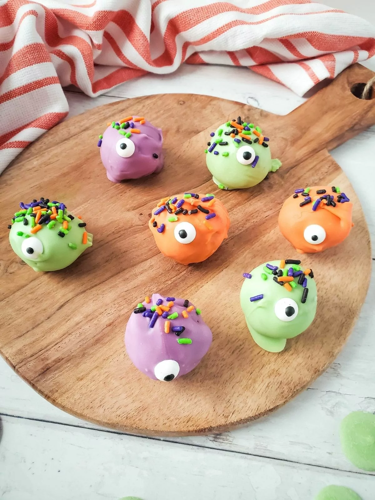 Monster eye cookie balls on cutting board.