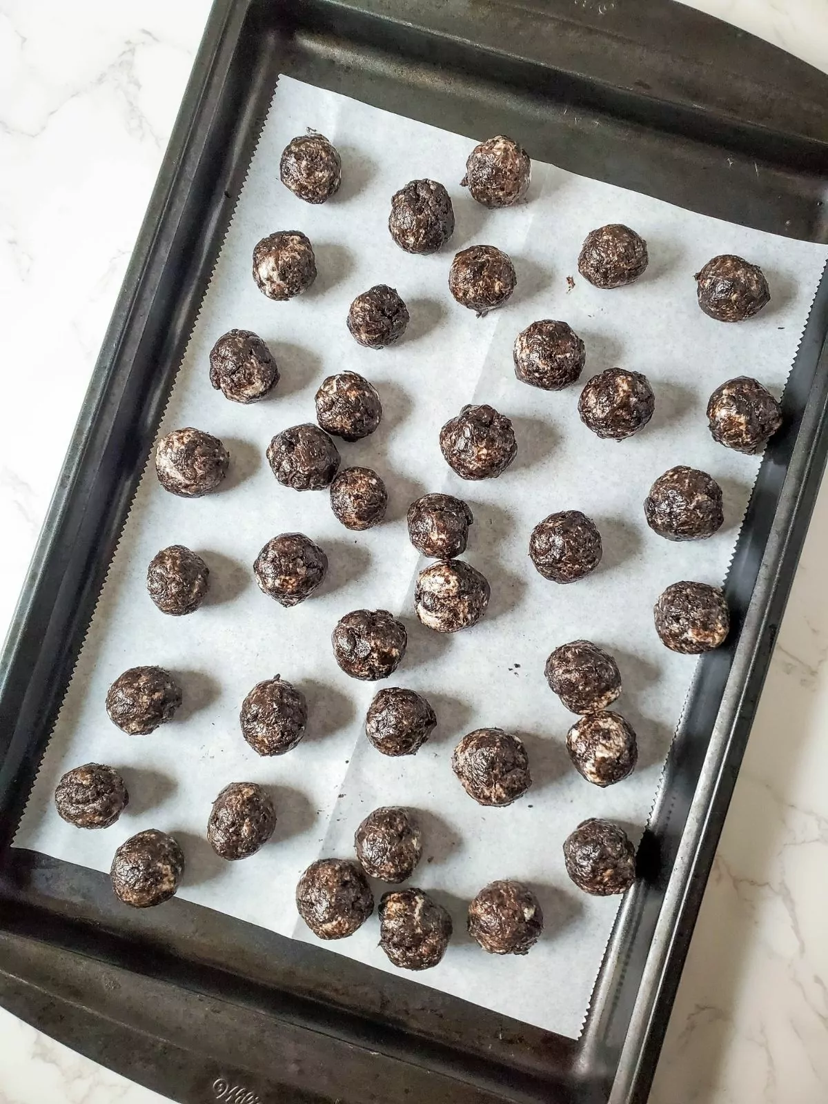 Oreo and Cream cheese cookie balls on baking tray.