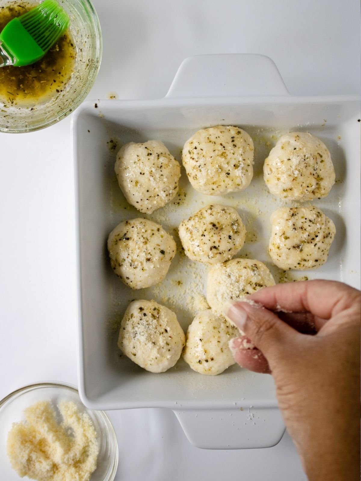 Grands biscuits sprinkled with Parmesan cheese.