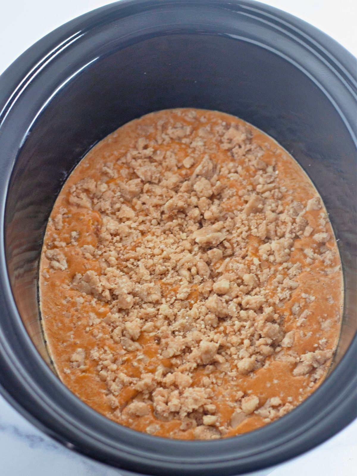 Add cobbler topping to pumpkin mixture in crock pot.