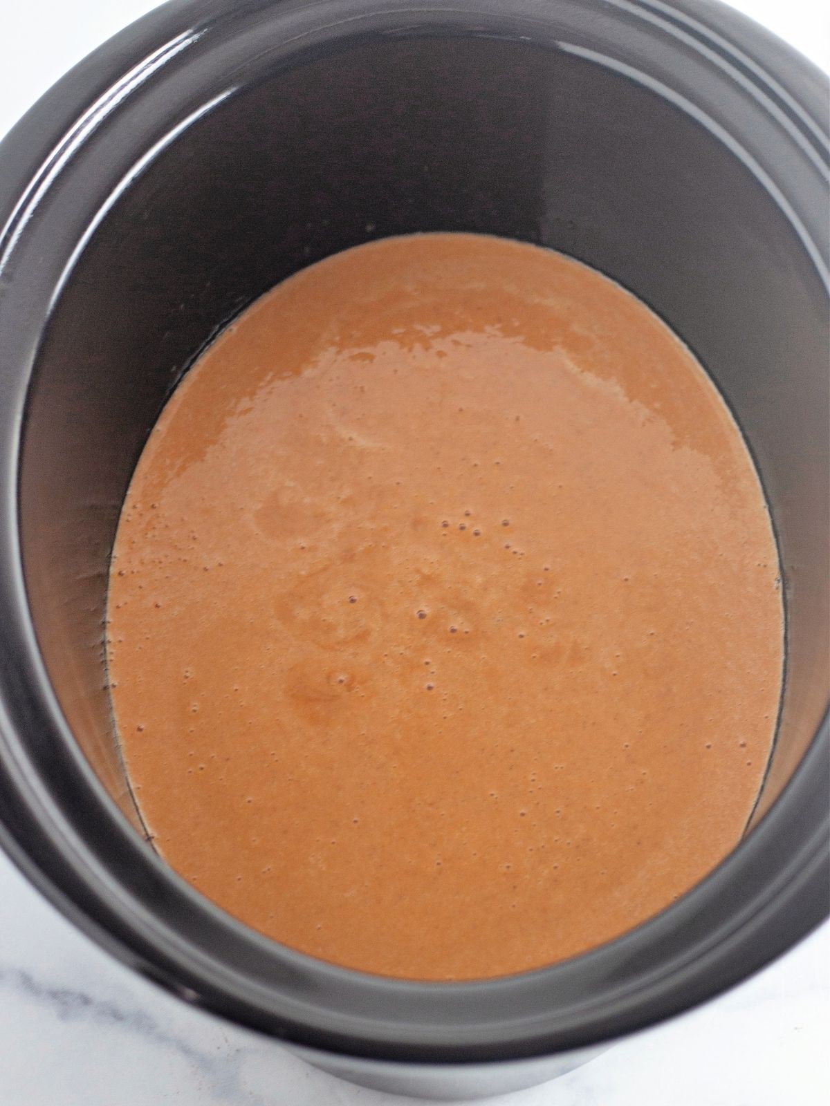 Add ingredients to crock pot for Pumpkin Cobbler.