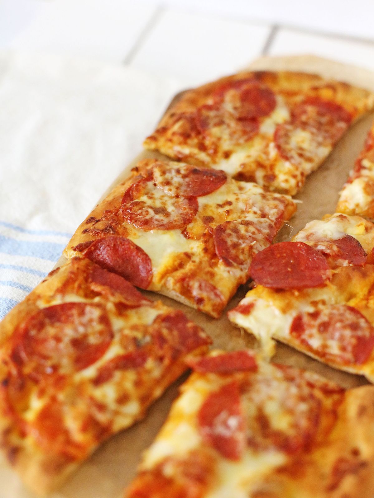 baked sliced pizza on flatbread.