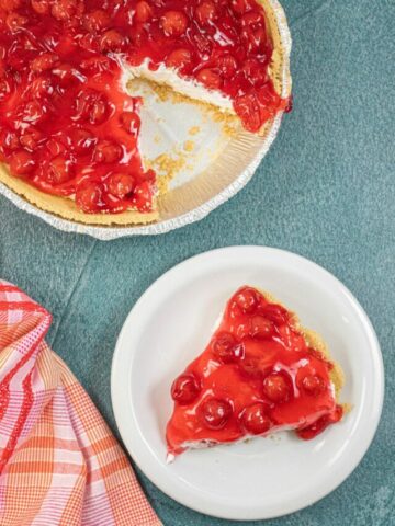 slice of no bake cheesecake pie on white plate.