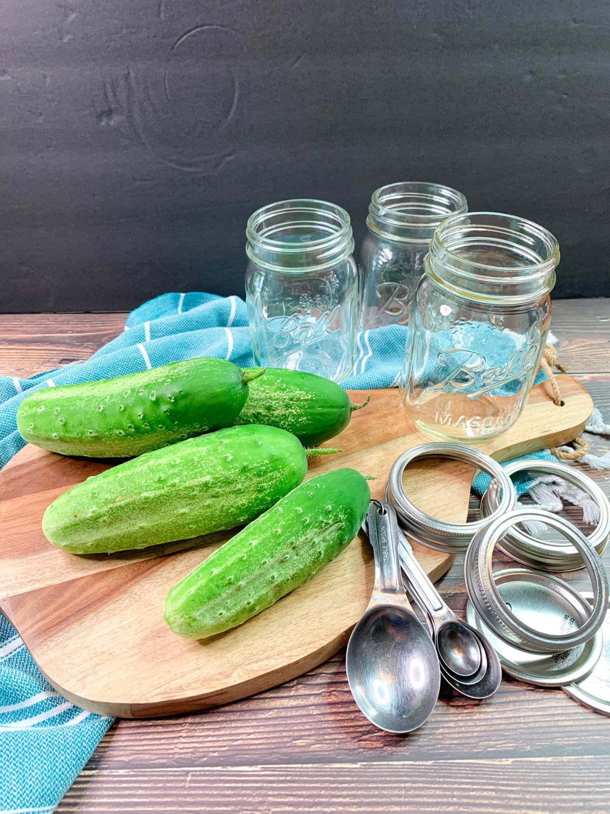 cucumbers, mason jars, measuring spoons.