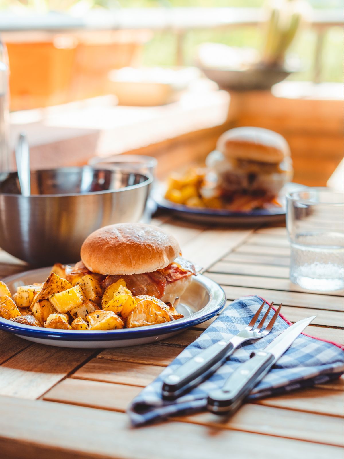 burger, potatoes on plate for dinner.