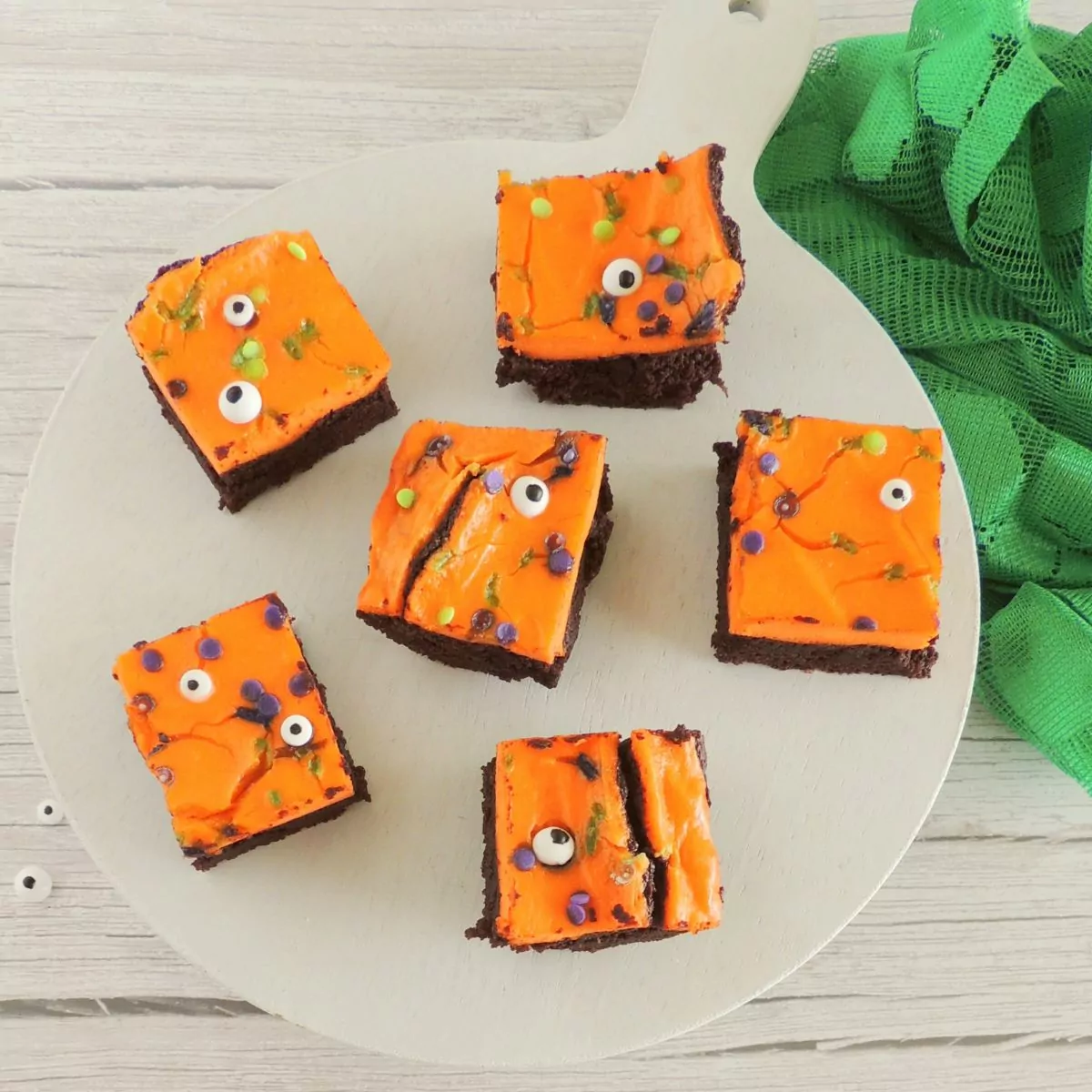 Brownies for Halloween on white plate with green napkin.
