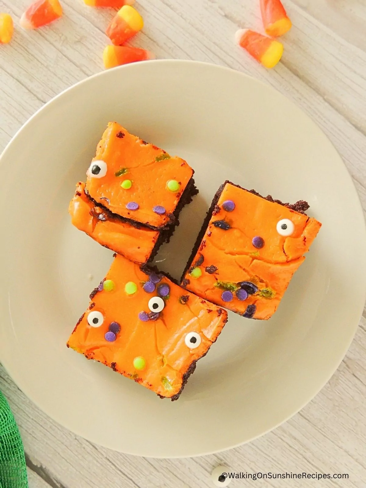 Halloween decorated brownies on plate.
