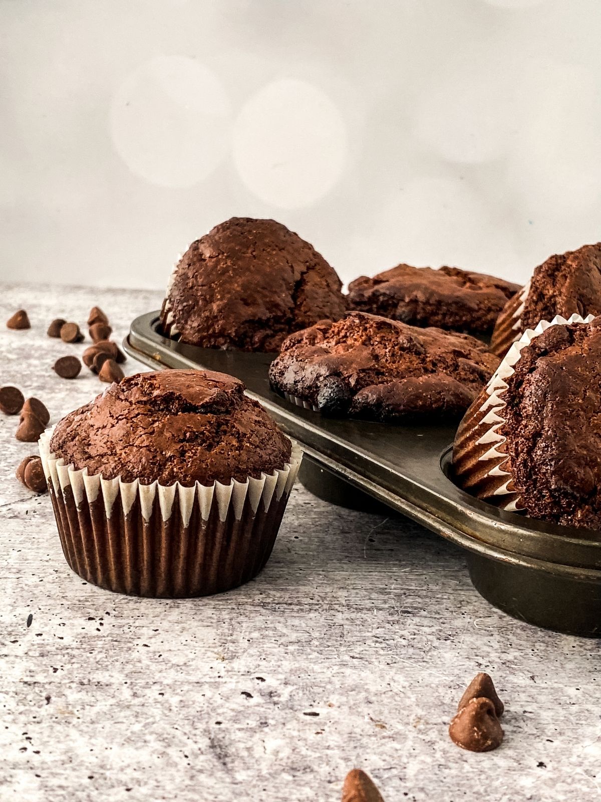 https://walkingonsunshinerecipes.com/wp-content/uploads/2023/08/first-hero-photo.-homemade-chocolate-chip-muffins.jpg