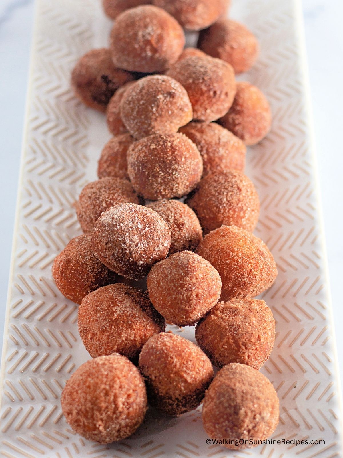 cinnamon sugar donut holes on plate.
