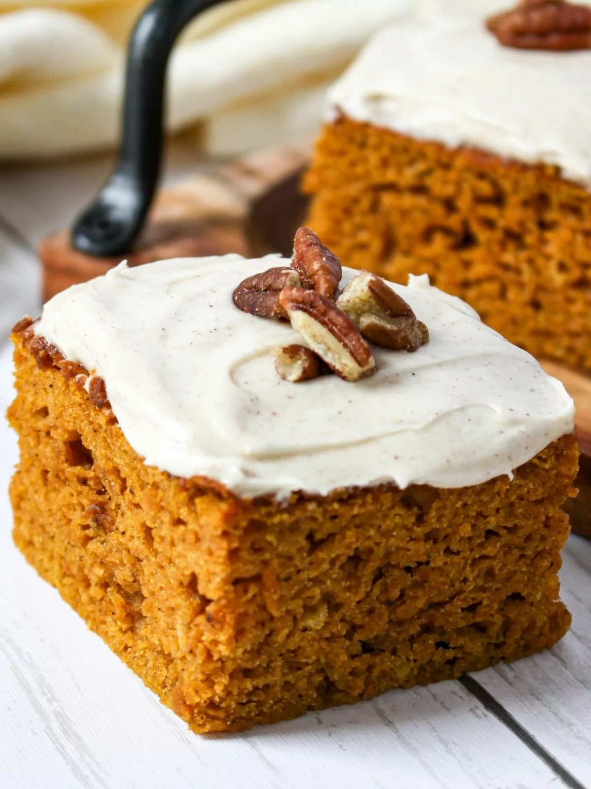 homemade pumpkin spice cake bars with pecans on top.