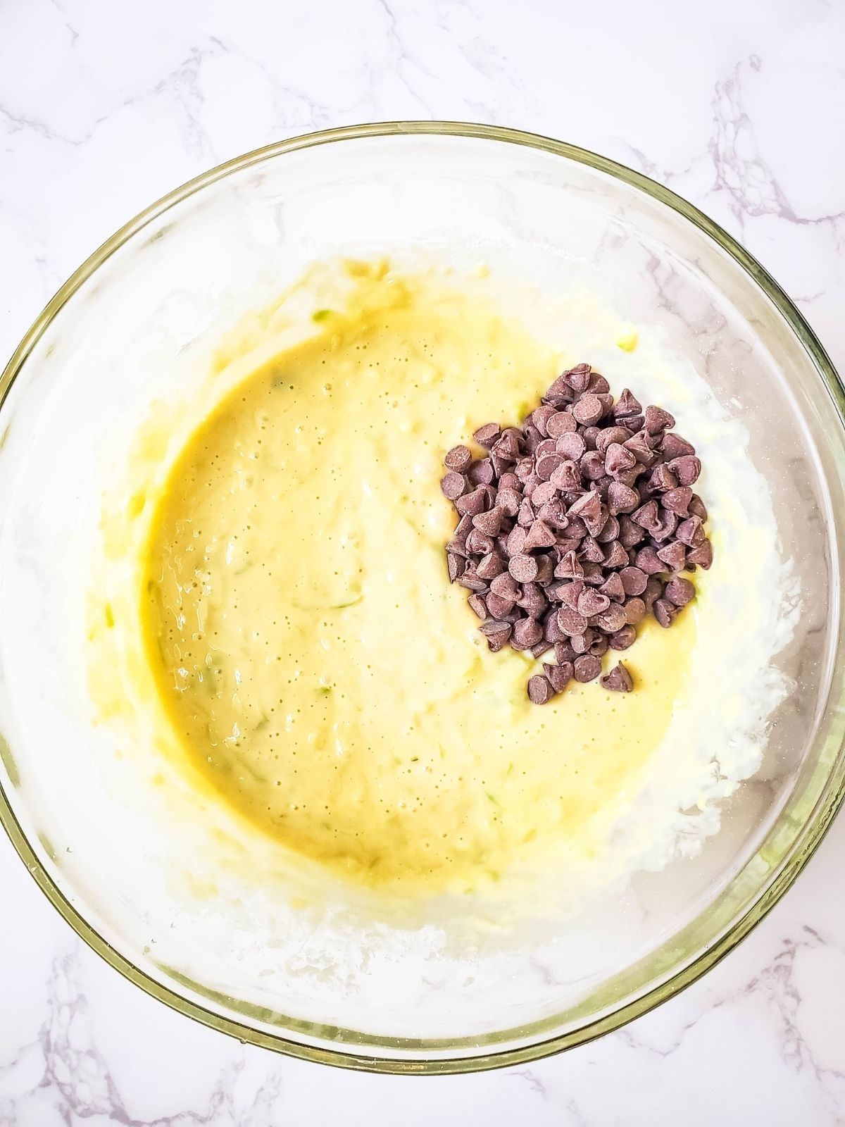 Add chocolate chips to zucchini bread batter.