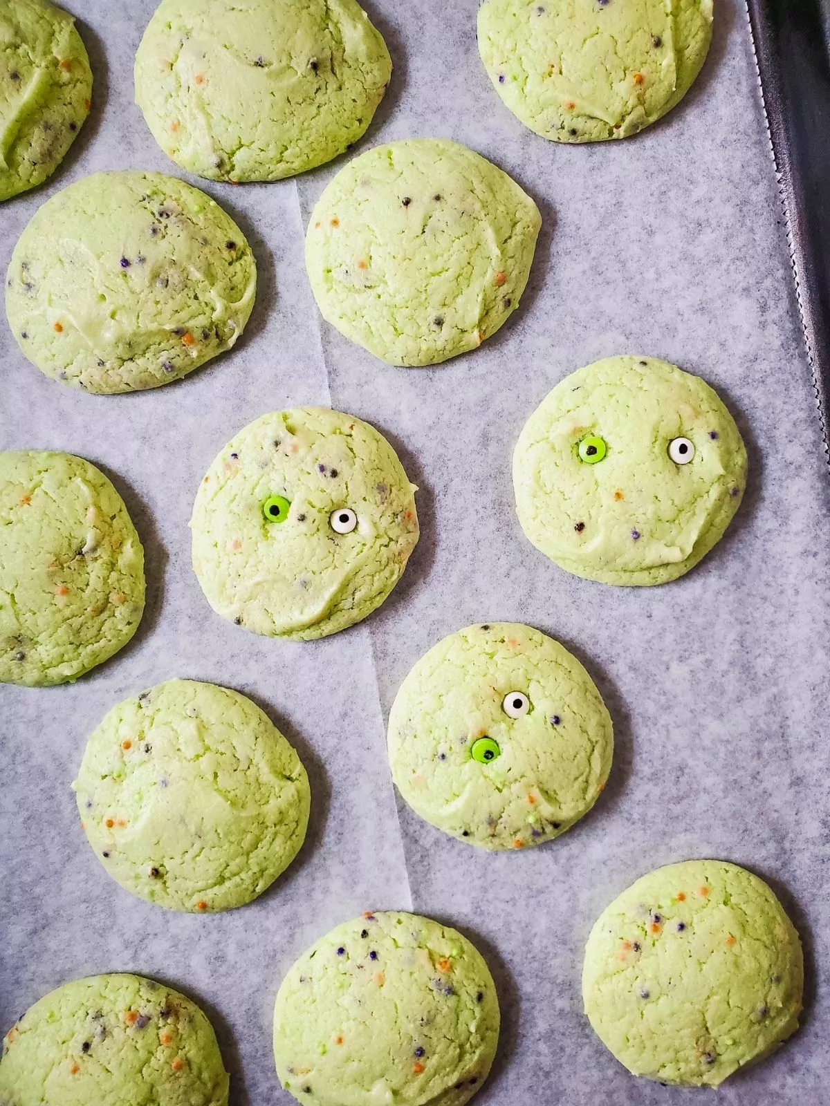 Halloween monster cookies baked on tray.