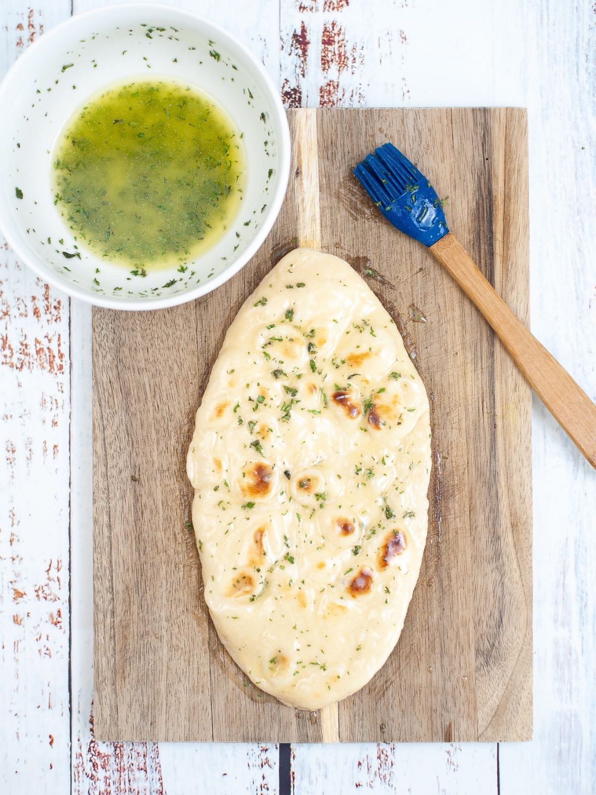 brush garlic butter mixture on flatbread.